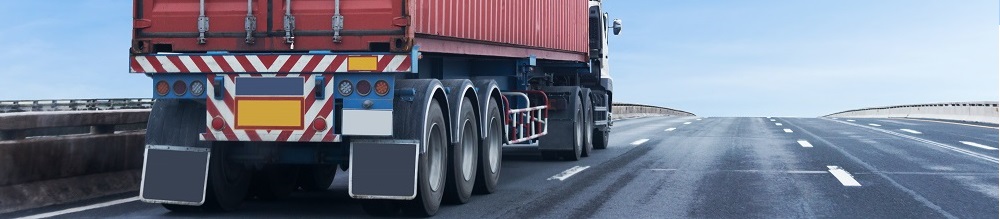 Truck on highway road with red  container, transportation concept.,import,export logistic industrial Transporting Land transport on the asphalt expressway with blue sky